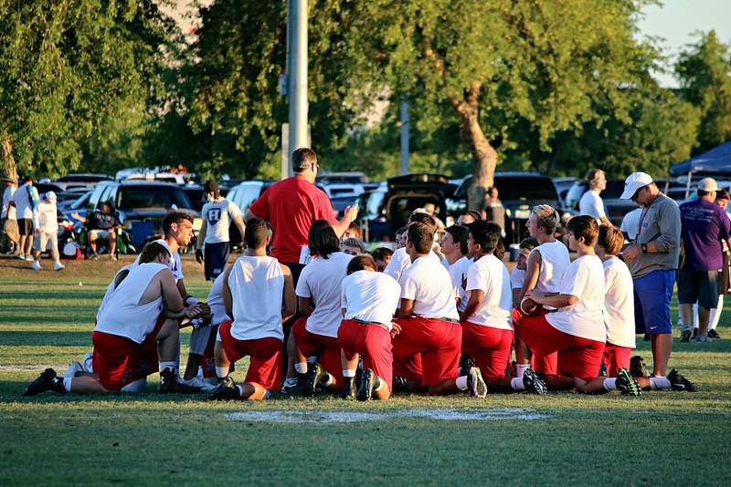 Football coach counsels team members
